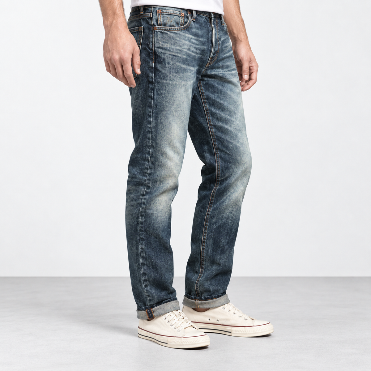 Stonewashed tapered cotton blend jeans in stonewashed blue, side view on a model