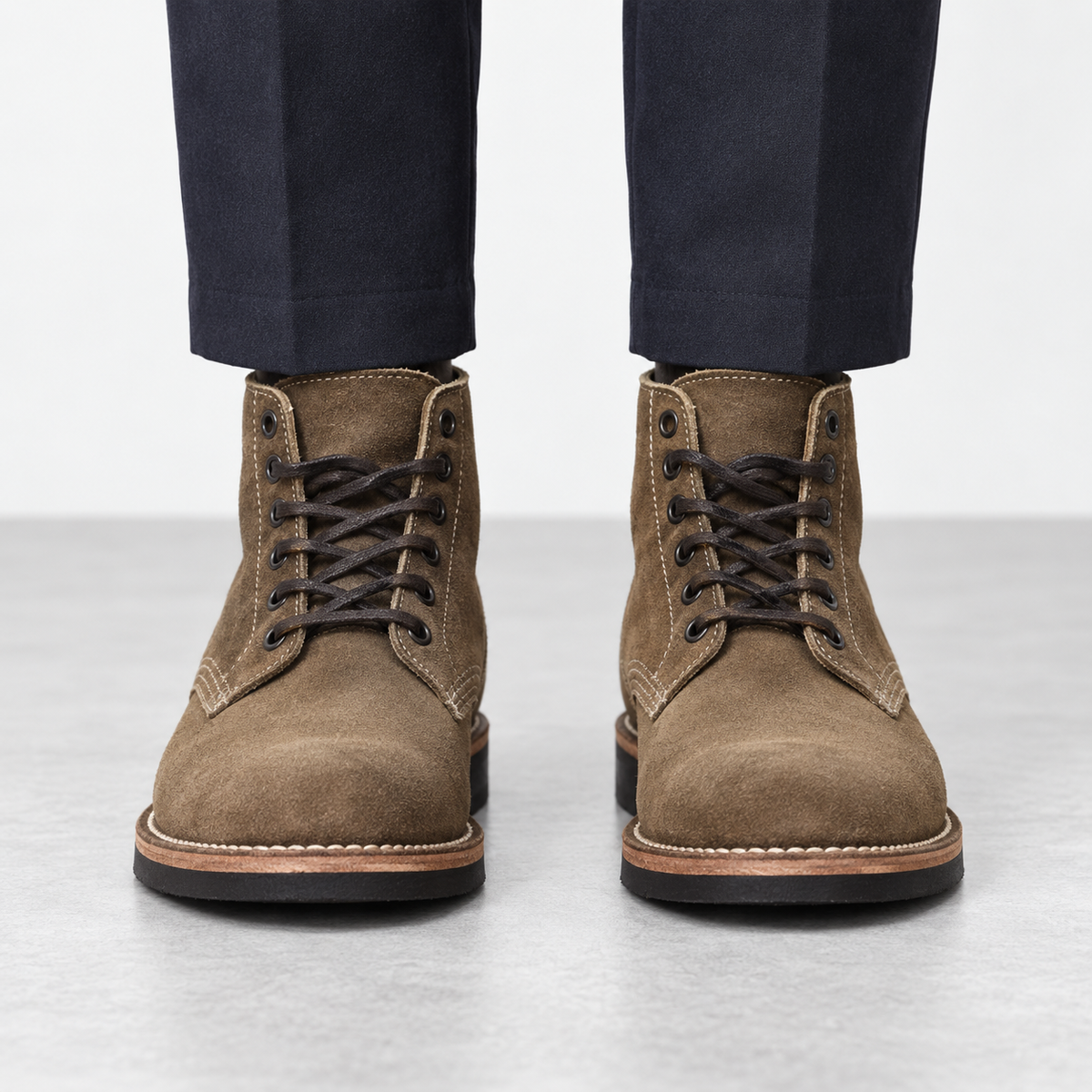Suede plain toe lace up ankle boots in brown, front view on a model