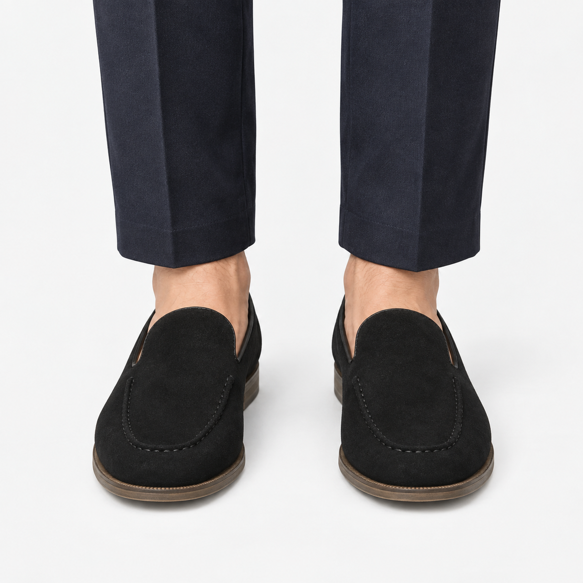 Suede slip on loafers with apron stitching in black, front view on a model