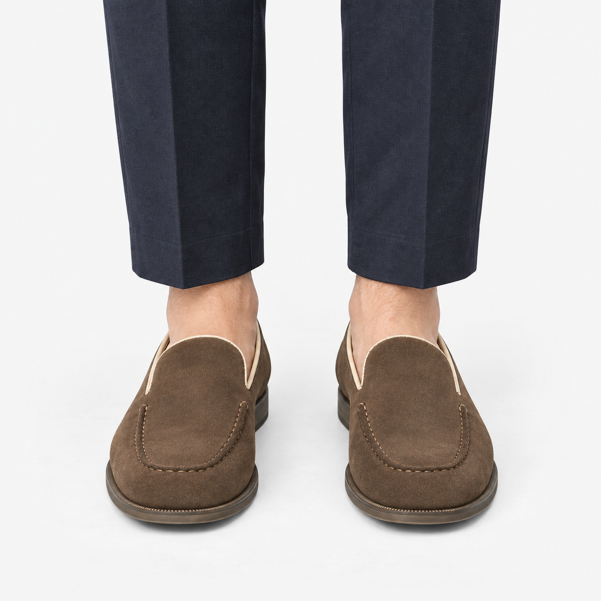 Suede slip on loafers with apron stitching in brown, front view on a model