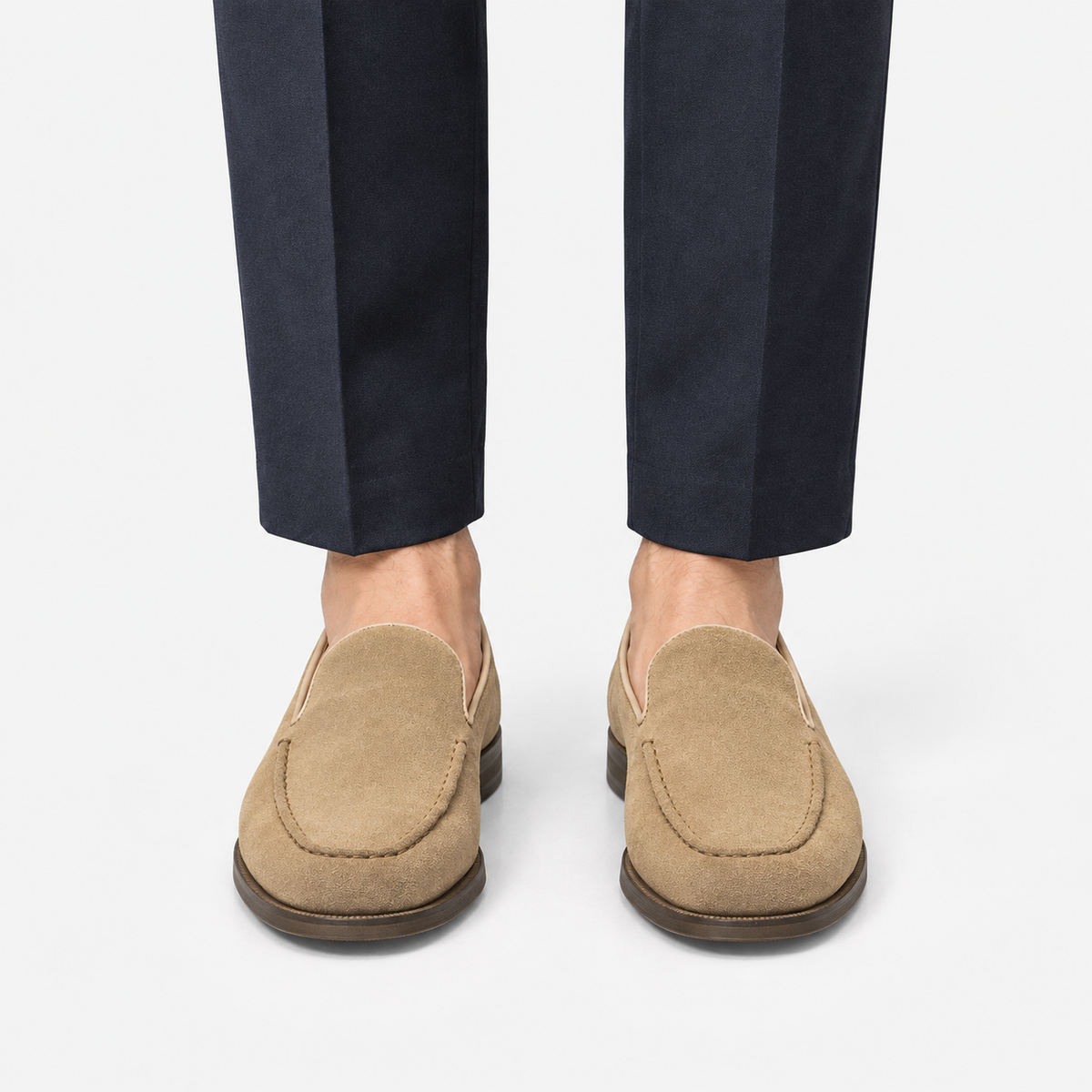 Suede slip on loafers with apron stitching in sand, front view on a model