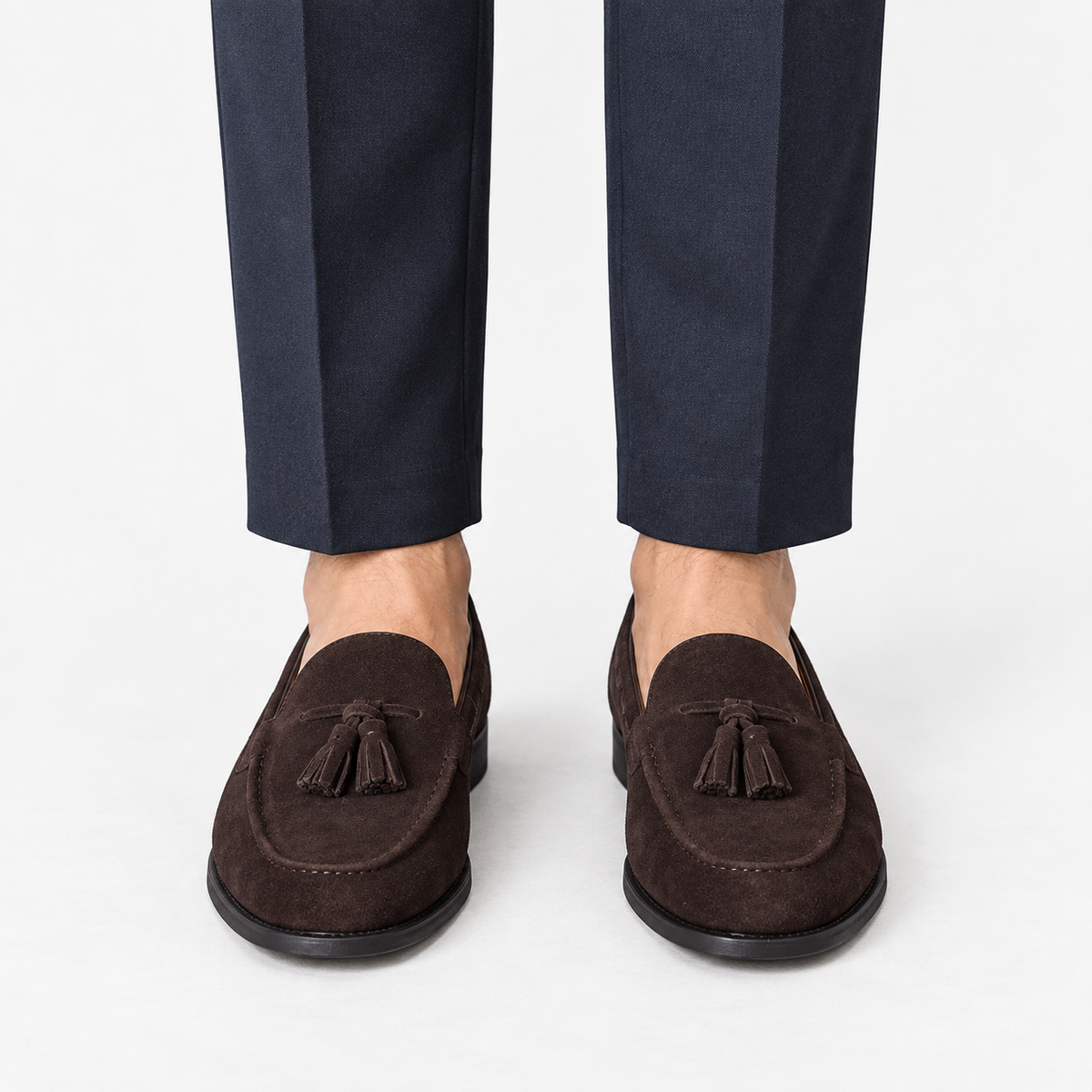 Suede tassel loafers with rubber soles in dark brown, front view on a model