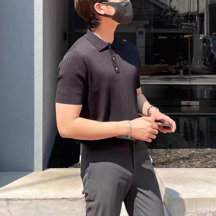 Man wearing AntoniosClothing Elastic Casual Polo T-Shirt in black, modern striped pattern, outdoors.