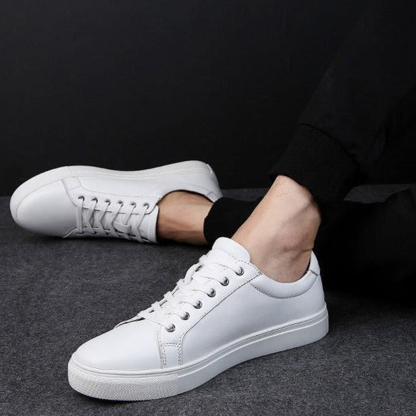 White Antonios Casual Breathable Leather Sneakers for men on foot, solid pattern, suitable for all-season casual wear.