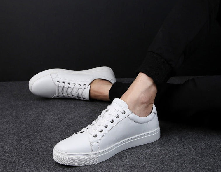 White Antonios Casual Breathable Leather Sneakers for men on foot, solid pattern, suitable for all-season casual wear.
