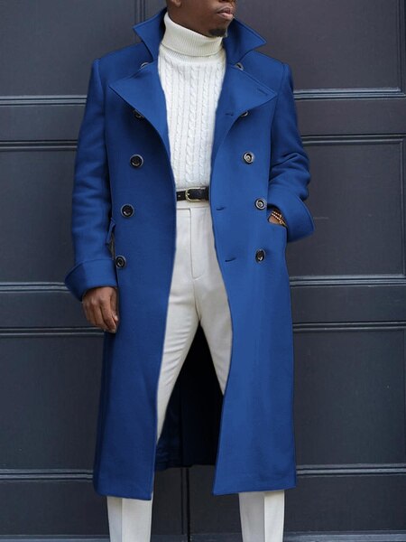 Elegant men's solid blue coat with double-breasted design, showcased with stylish outfit.