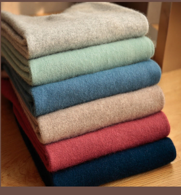 Stack of assorted colors of Antonios Autumn Knitted Sweaters for men showcasing fabric texture and variety.