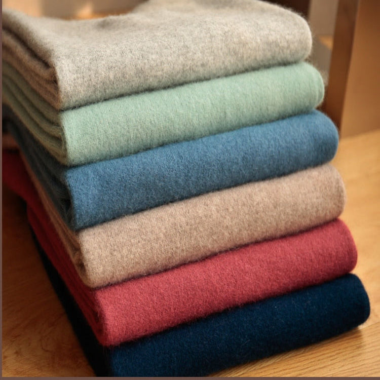 Stack of Antonios Wool Winter V-Neck Sweaters in various colors.