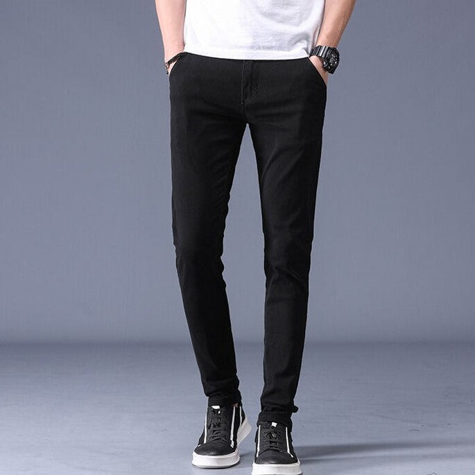 Antonios Slim Fit Cotton Stretch Trousers Men in black, styled with sneakers.