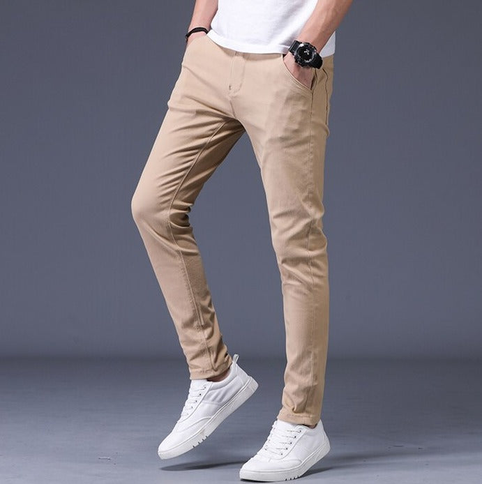 Antonios Slim Fit Cotton Stretch Trousers Men in beige, styled with white sneakers and a casual shirt.