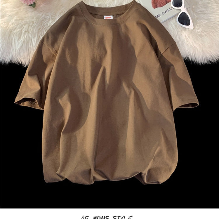 Antonios Oversized Casual Cotton T-Shirt in brown displayed on a cozy background with sunglasses and decor.