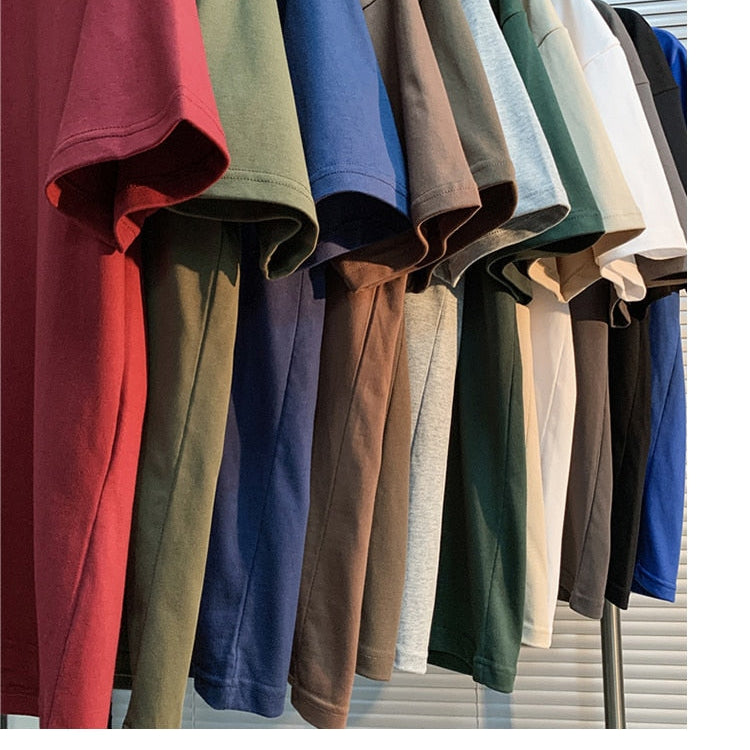 T-shirts in various colors hanging on a rack for display.
