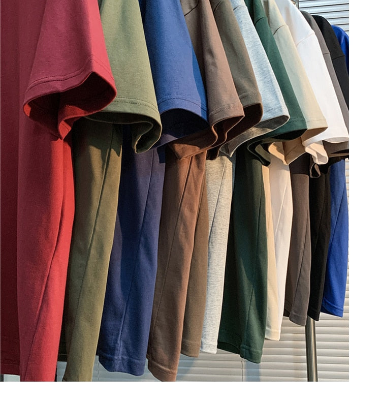 T-shirts in various colors hanging on a rack for display.