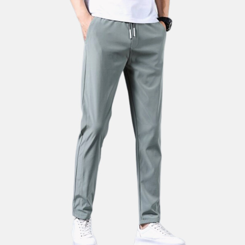 Antonios Casual Slim Fit Trousers in gray, modeled with white sneakers, showcasing casual style for spring and summer.