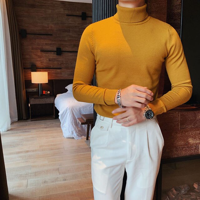 Antonios Perry Sweater in mustard color, showcasing a solid pattern and elegant style, featuring a man in a cozy indoor setting.