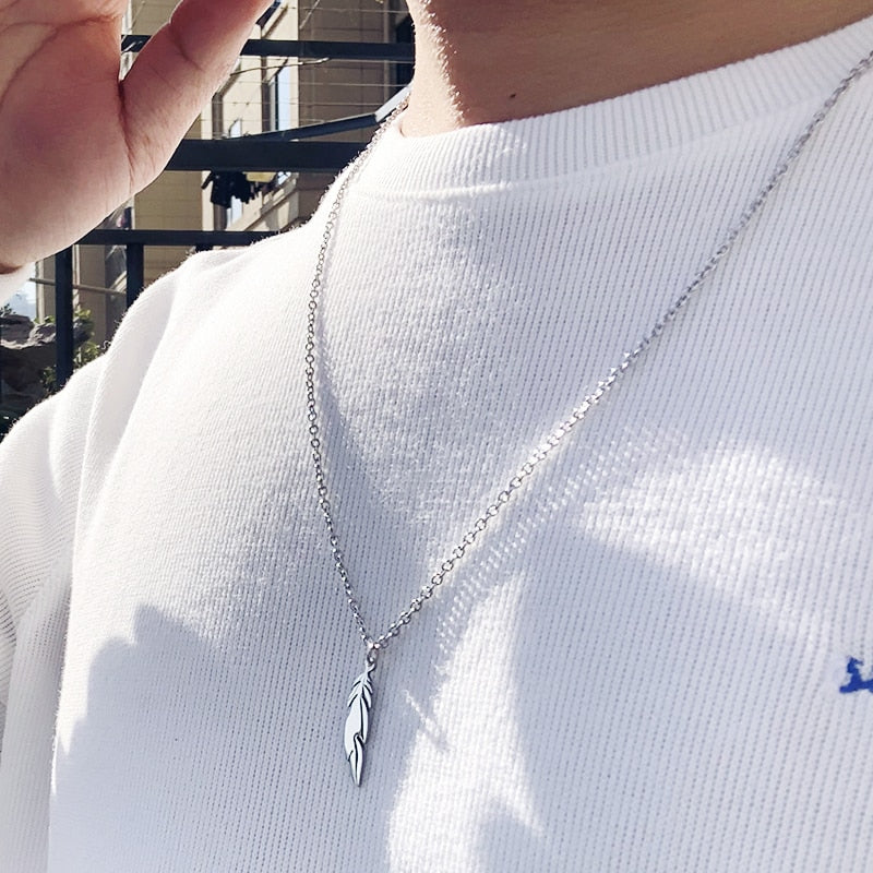 Antonios Minimalist Stainless Steel Necklace on man in white shirt outdoors.