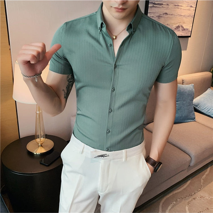 Homme short sleeve shirt in olive green, striped pattern, worn by a man in a casual setting.