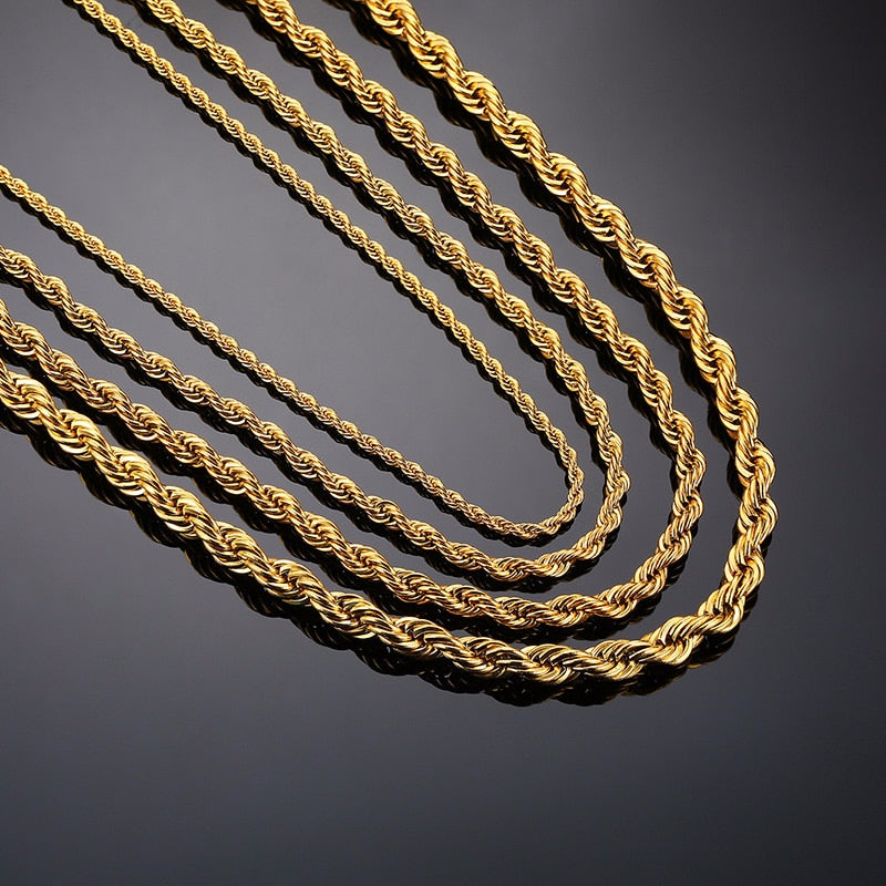 Antonios Twist Stainless Steel Necklace Men in gold finish laid flat on a dark surface.