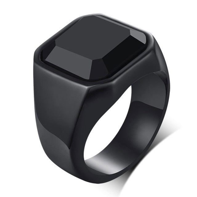 Modern stainless steel men's ring with black gemstone centerpiece.