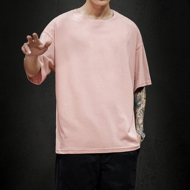 Men's Antonios Pure Cotton T-Shirt in soft pink, featuring rounded sleeves and stylized bottom hem for a smart casual look.