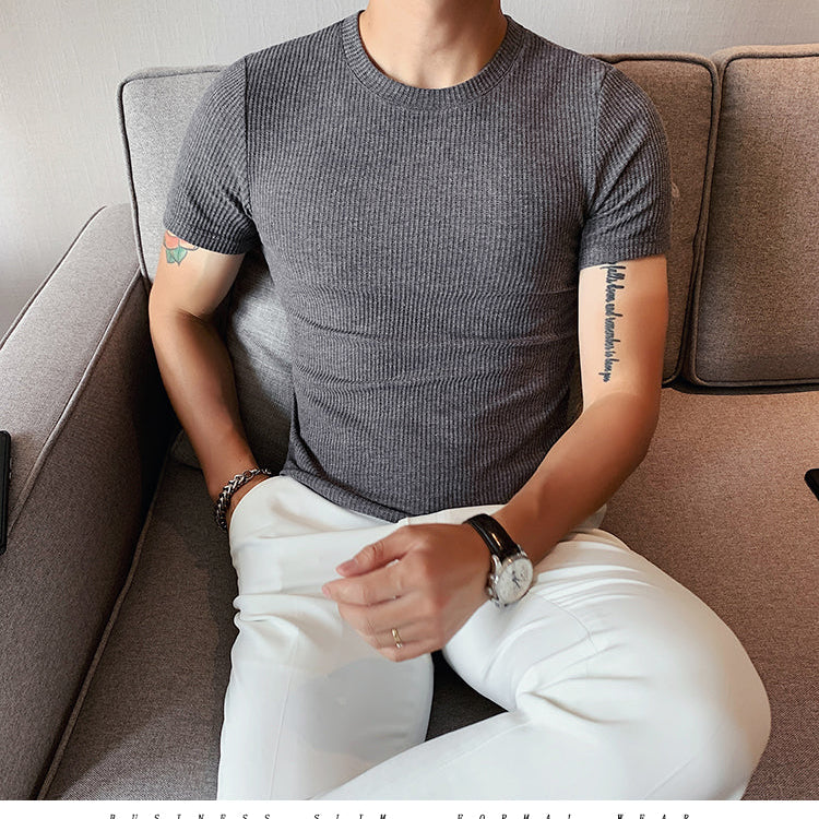 Spring Slim Fit T-Shirt in gray, featuring a solid-stripe pattern, worn by a man seated on a sofa.