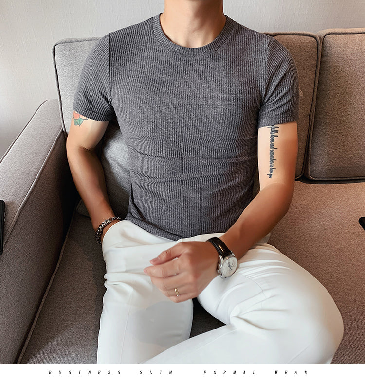 Spring Slim Fit T-Shirt in gray, featuring a solid-stripe pattern, worn by a man seated on a sofa.