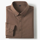 A folded brown long-sleeve button-down shirt with a classic collar and a single cuff, displayed on a clean white background.