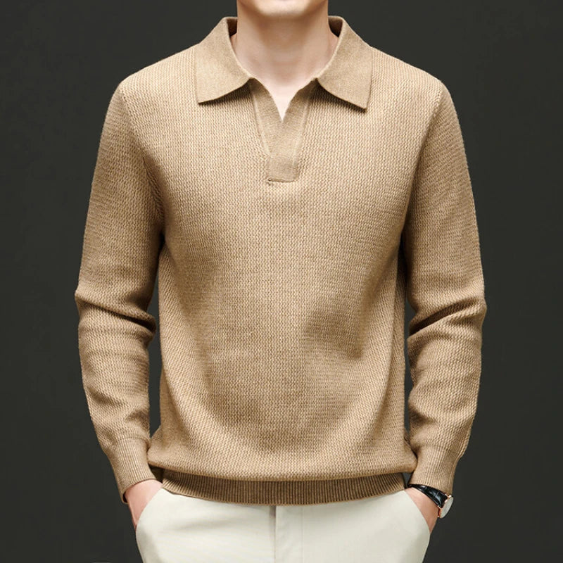 Beige sweater worn by a mannequin against a dark background
