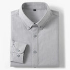 Folded gray shirt with button details on a white background