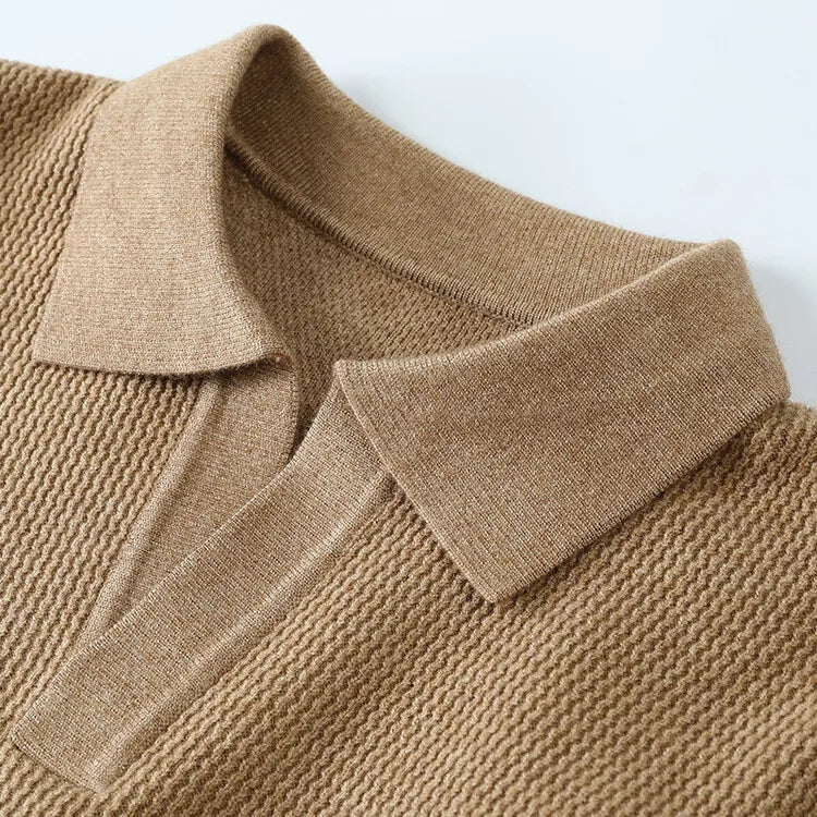 Close-up of a brown knitted sweater with a collar on a light background