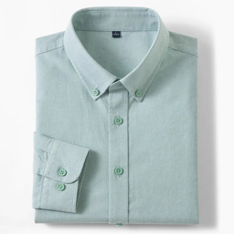A folded light green sage long-sleeve button-down shirt with a pointed collar and matching buttons, displayed on a clean white background.
