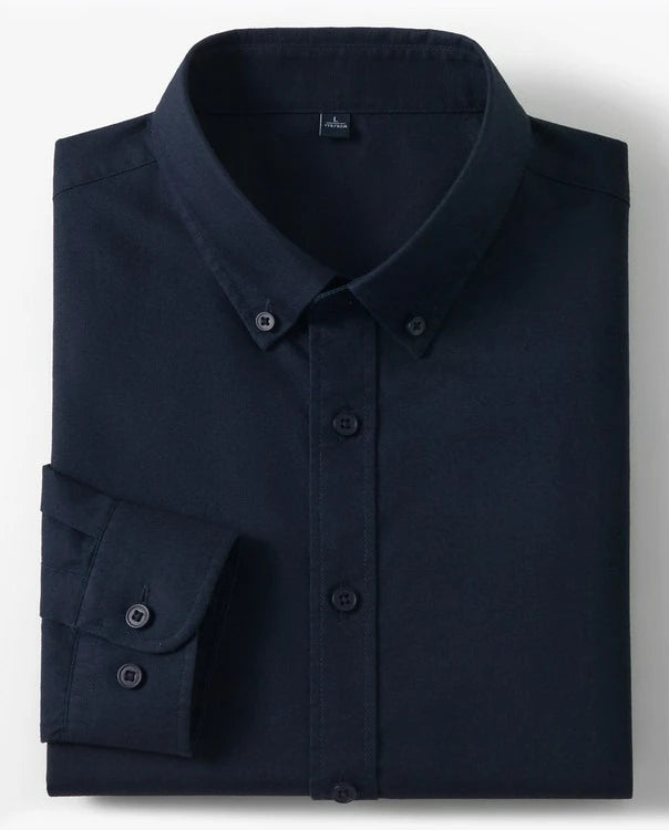 A folded dark navy long-sleeve button-down shirt with a pointed collar and button cuffs, shown on a light gray background with two small inset images on the right showing cotton and a fabric close-up.