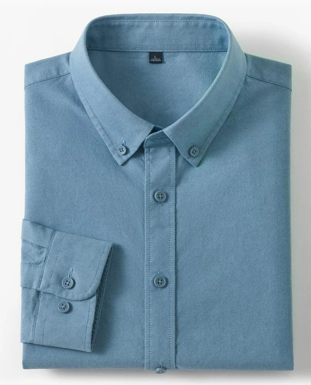 A folded light blue long-sleeve button-down shirt with a button collar and button cuffs, shown on a white background with two small inset images on the right showing cotton and fabric texture.