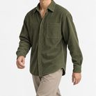 Relaxed corduroy shirt with a curved hem in olive green, three-quarter model view