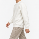 Heavyweight cotton crew neck sweatshirt in white, three-quarter model view
