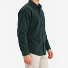 Washed cotton corduroy shirt with a clean front in dark green, three-quarter model view