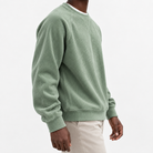 Ribbed raglan sweatshirt with a stitched neckline in sage green, three-quarter model view