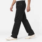 Washed cotton twill five pocket trousers in black, three-quarter model view