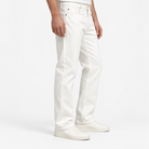Washed cotton twill five pocket trousers in white, three-quarter model view