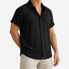 Short-sleeved cotton summer golf t-shirt in black, three-quarter model view