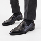 Leonardo genuine leather penny loafers in black, side worn view