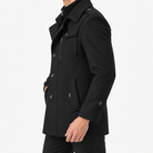 Button front coat with shoulder tabs and zip chest detail in black — male model side view