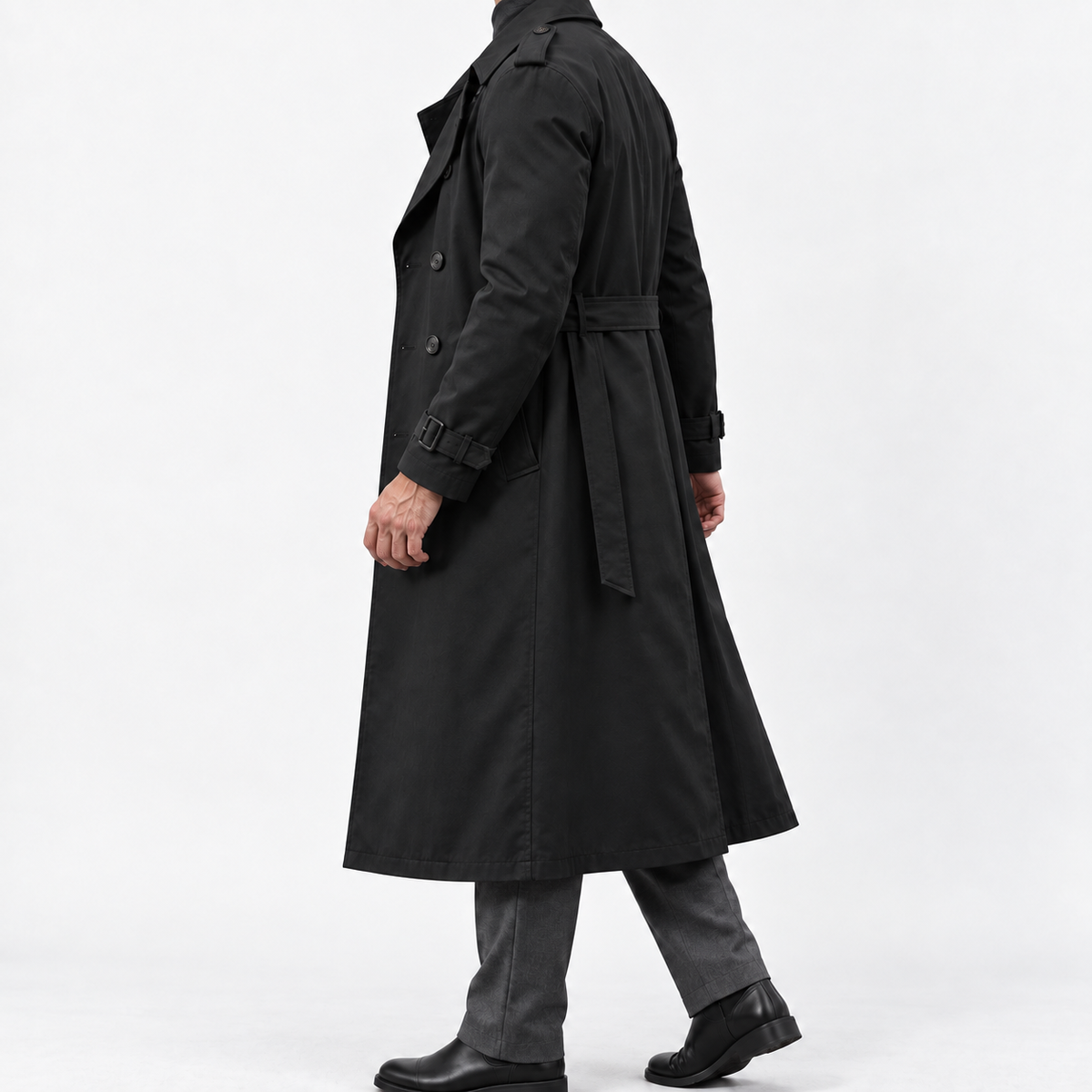 Long double breasted trench coat with a belt in black — side view on a male model