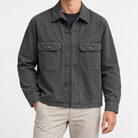 Washed cotton utility jacket with a zip front in charcoal — front view on a male model
