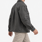 Washed cotton utility jacket with a zip front in charcoal — side view on a male model