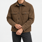 Washed cotton utility jacket with a zip front in brown — front view on a male model