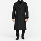 Long double breasted wool blend coat with cuff tabs in black — male model front view