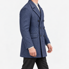 Herringbone double breasted coat with wide lapels in blue — male model side view