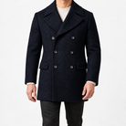 Herringbone double breasted coat with wide lapels in navy blue — male model front view