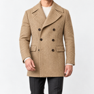 Herringbone double breasted coat with wide lapels in beige — male model front view